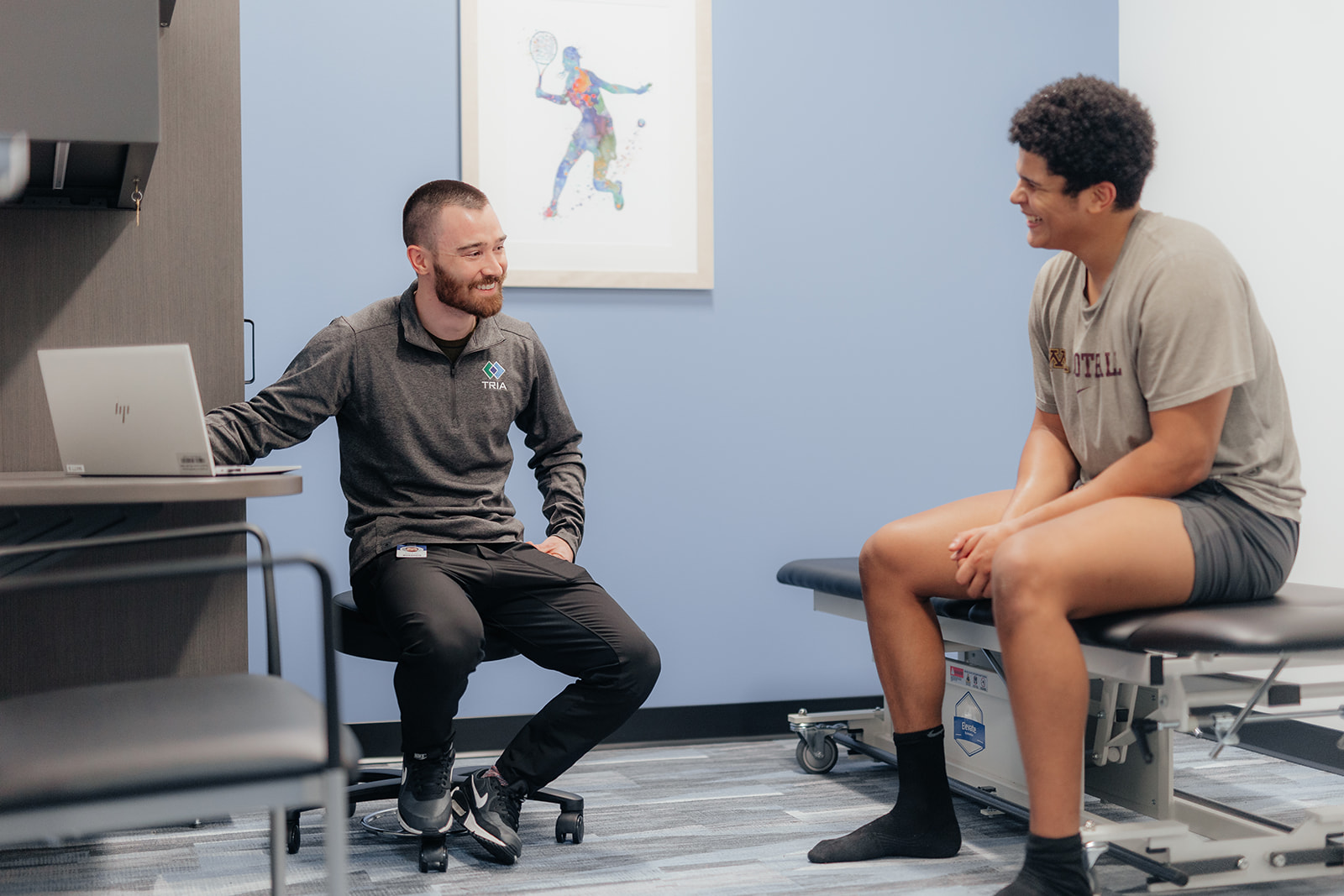A physical therapist evaluates his client.