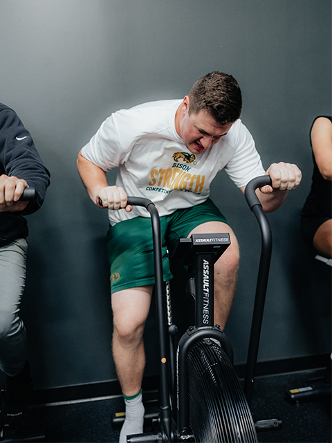 An athlete trains on a stationary bike.